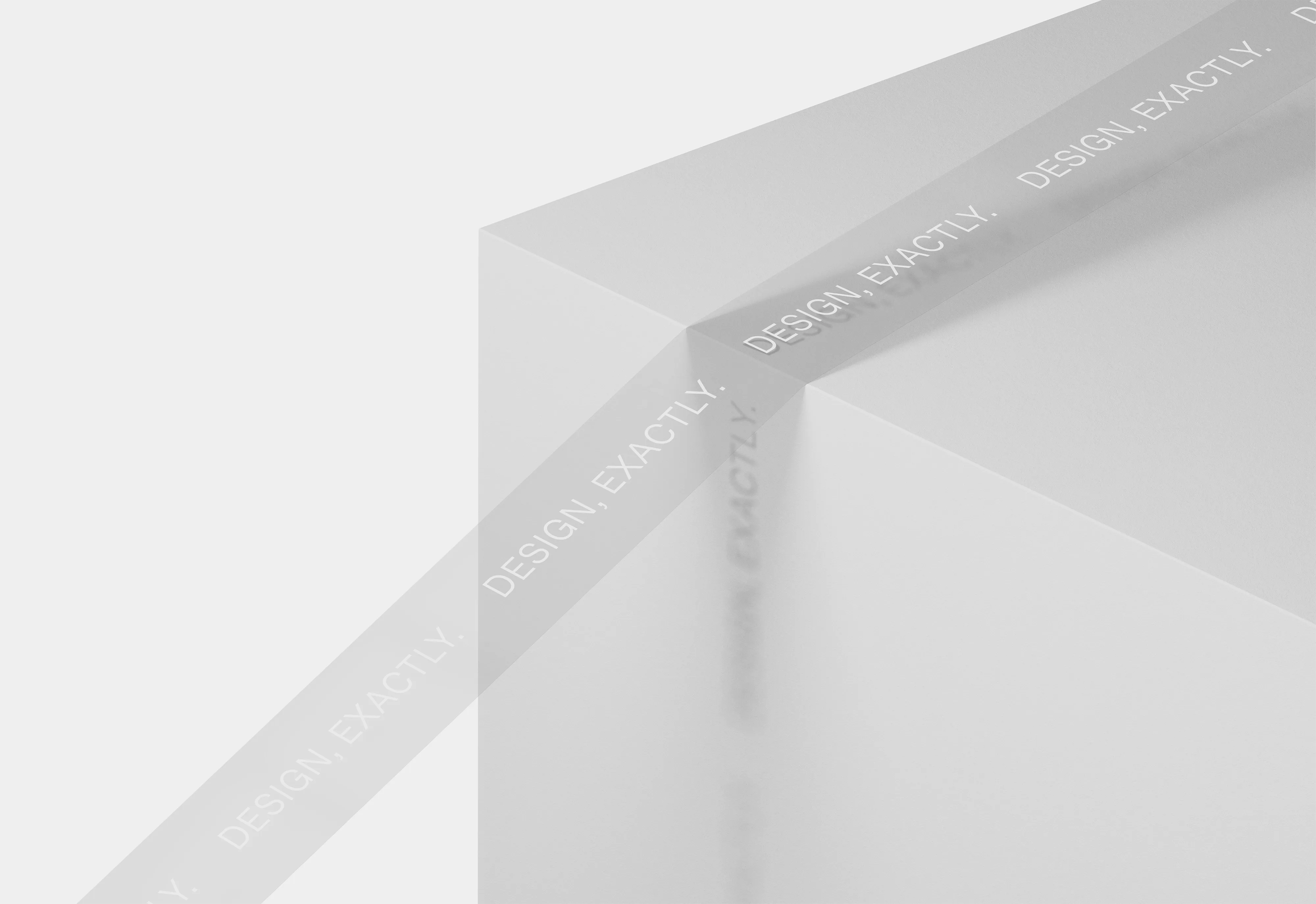 White, translucent tape wrapped around the corner of a white, square-edged surface, with the printed phrase 'DESIGN, EXACTLY.' repeated along the length of the tape.