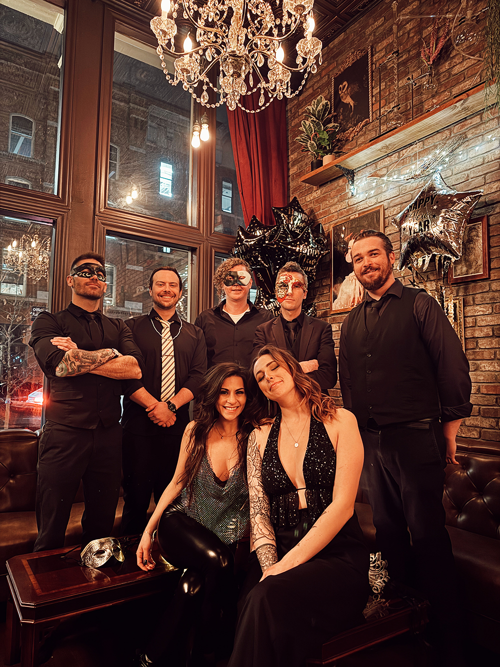 The whole staff dressed to the nines and wearing masquerade masks for new years eve