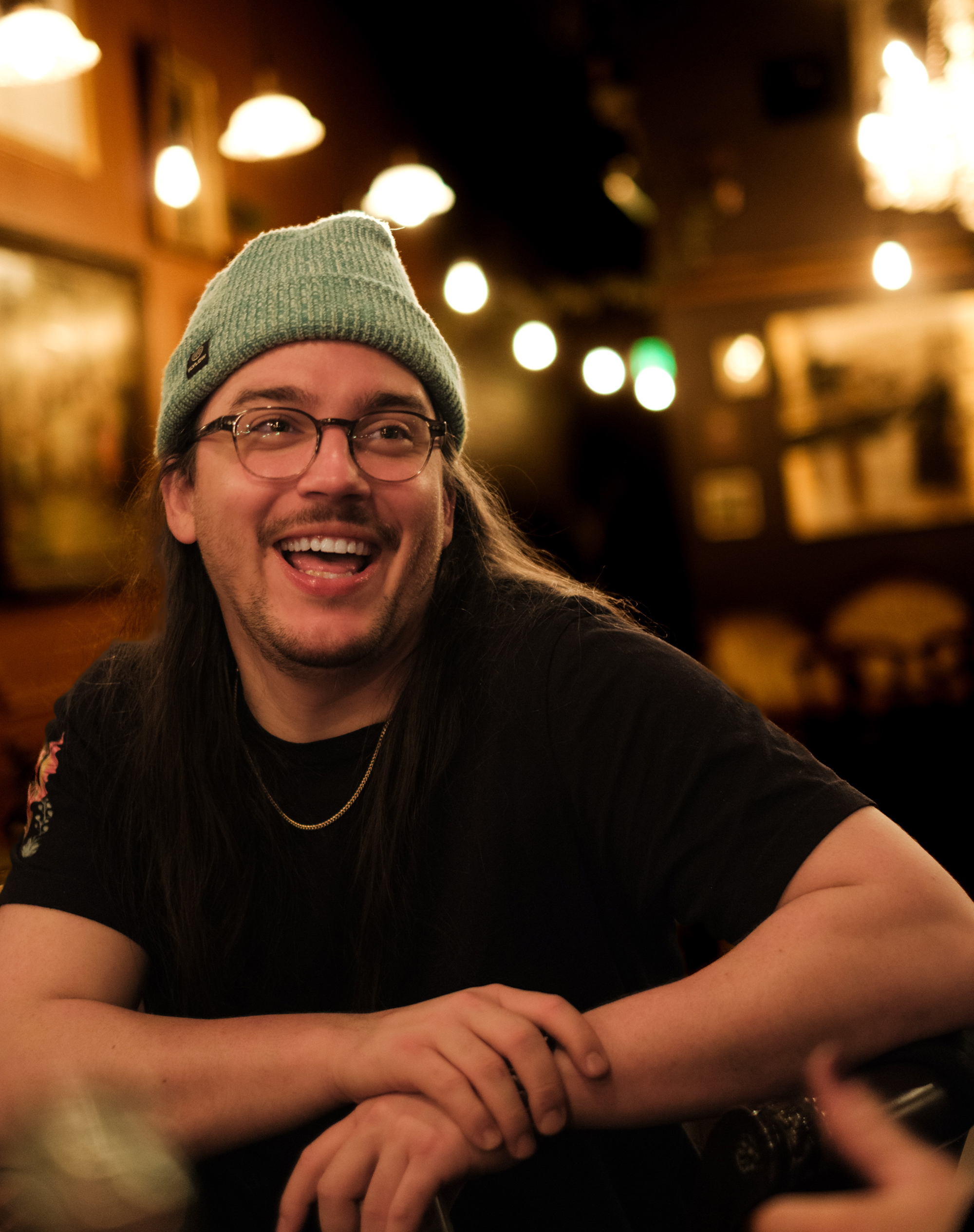 Regular and friend of the bar, Riley, sitting and laughing about a silly joke