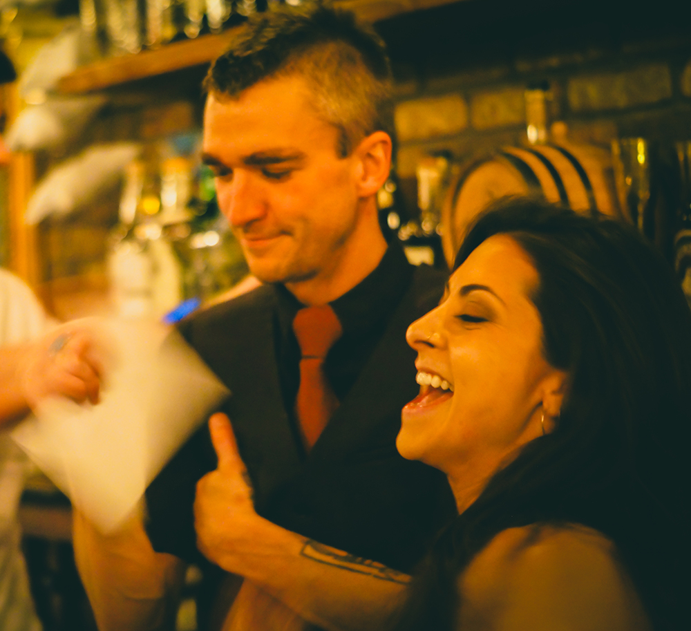 Beck and Jacob sharing a laugh behind the bar