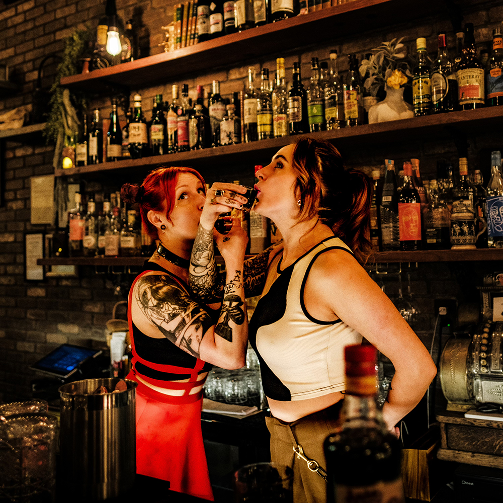 Bartender Glancy and Chey having a shot behind the bar