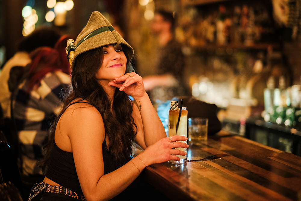 Server Beck holding a drink wearing a hat provided by Underberg