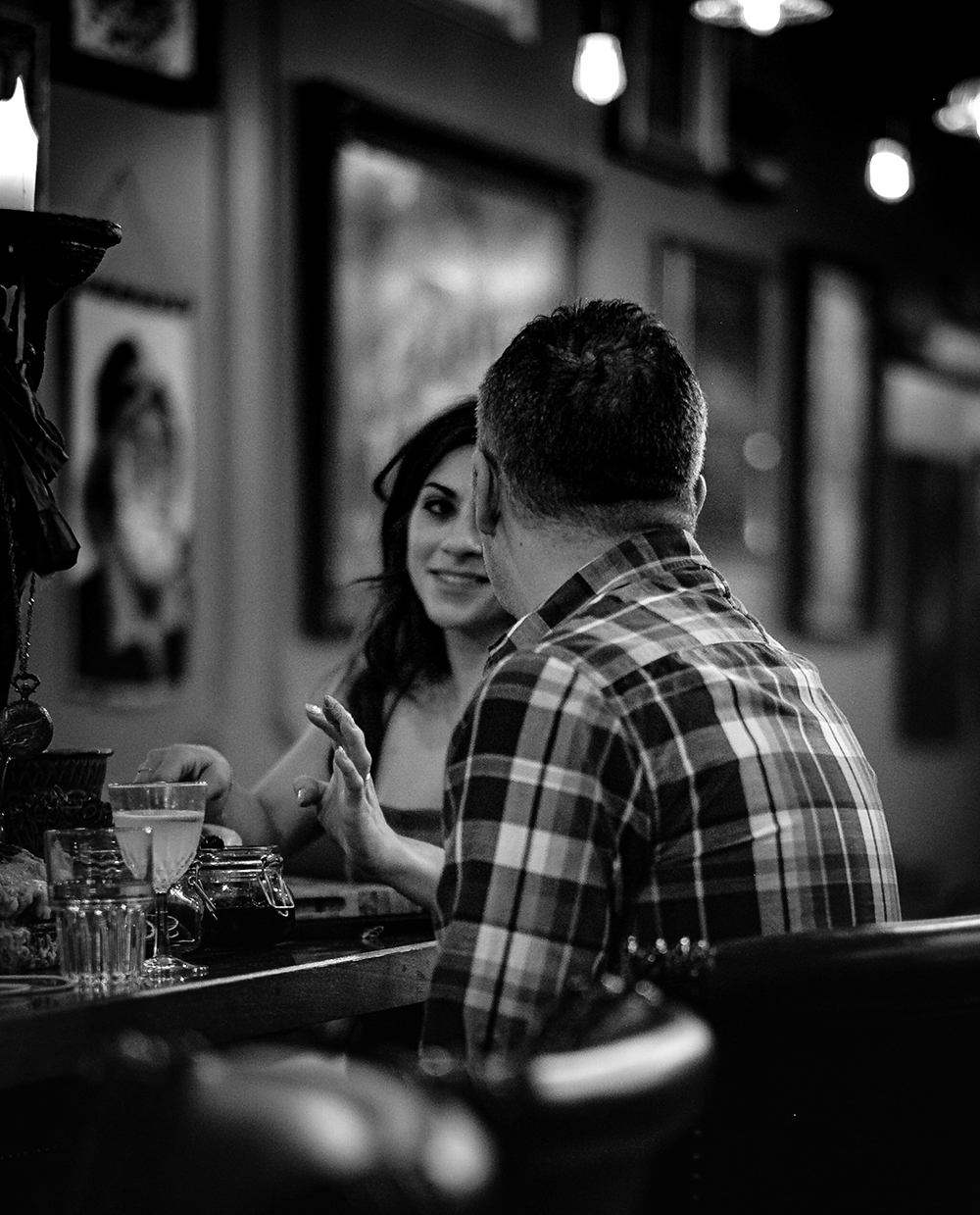 Belly and Beck talking in the moody lighting of the pub