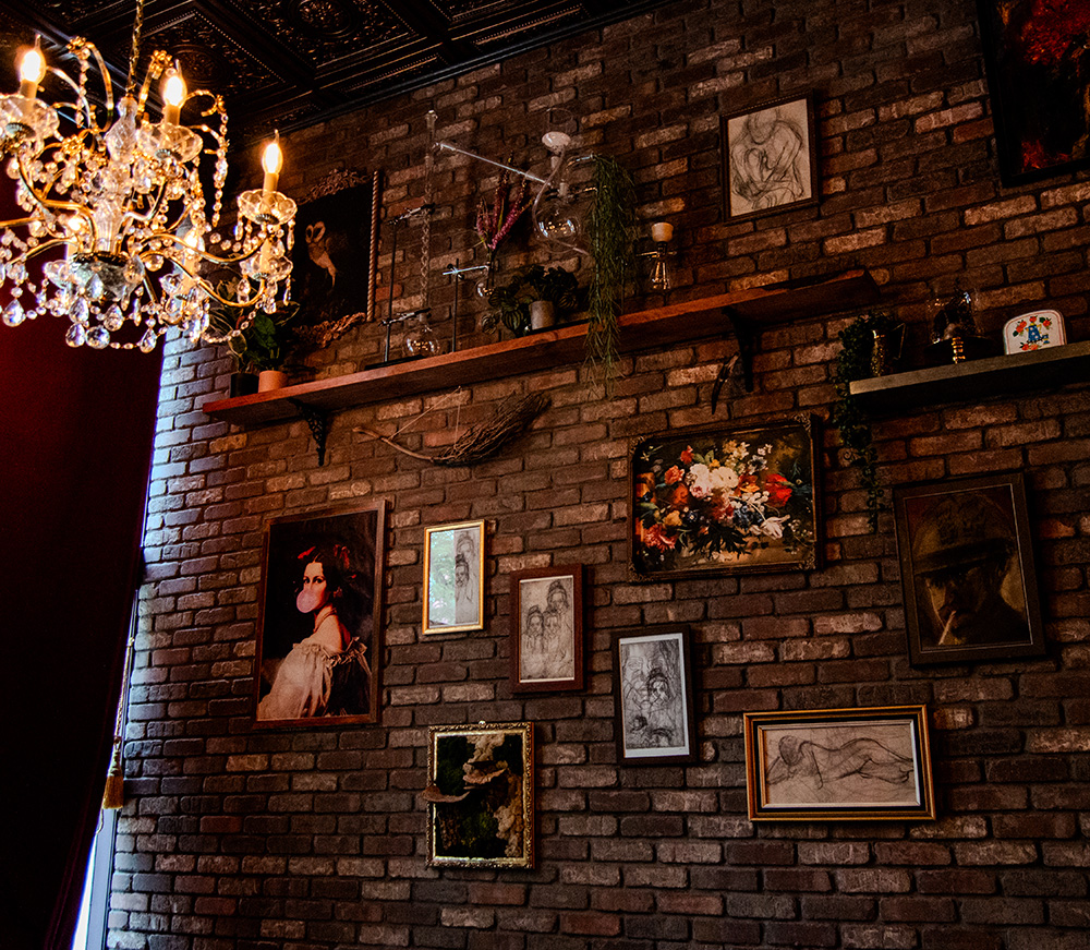 The wall inside the front entrance showcasing a number of original art pieces and other eccentric Bedlam decor