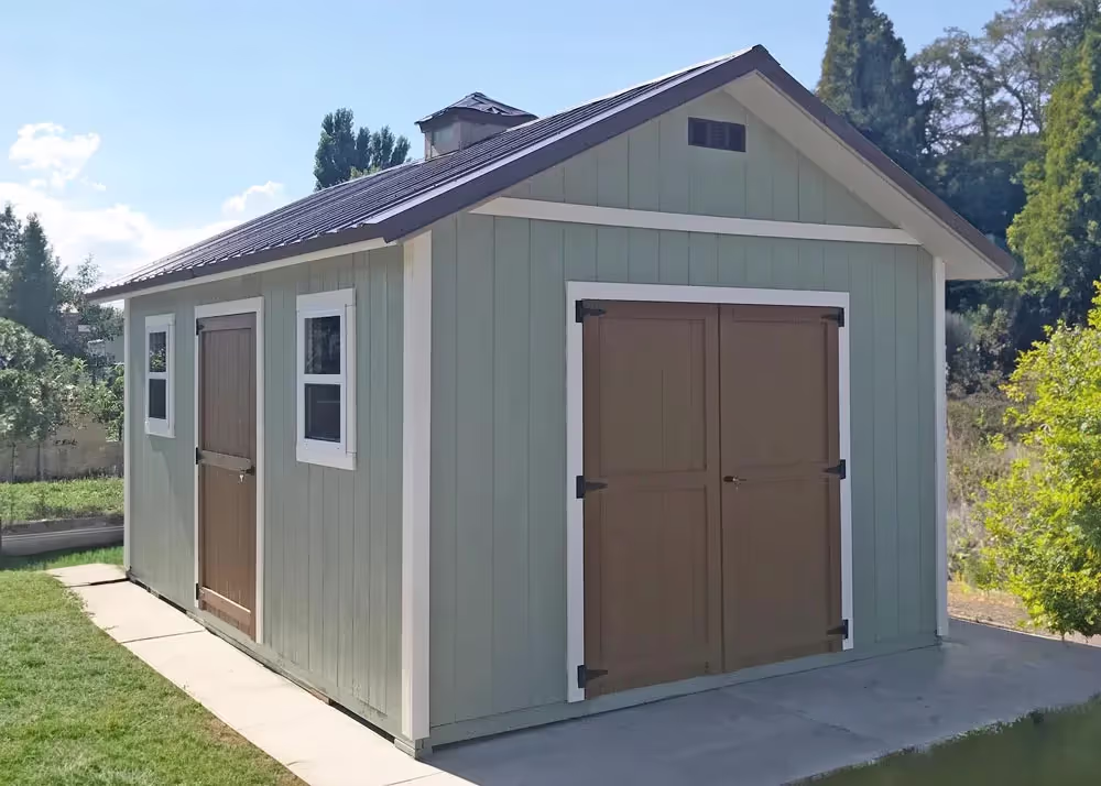 A 12 foot by 16 foot tall apex storage shed with 12" overhang and a metal roof