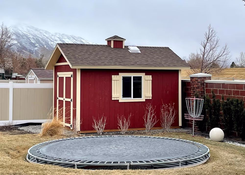 A beautiful 10 x 14 Tall Apex with a cupola and shutters on the window