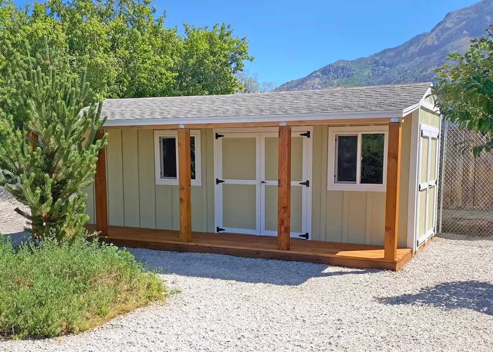A 10' by 20' Tall Apex storage shed with a porch overhang and deck