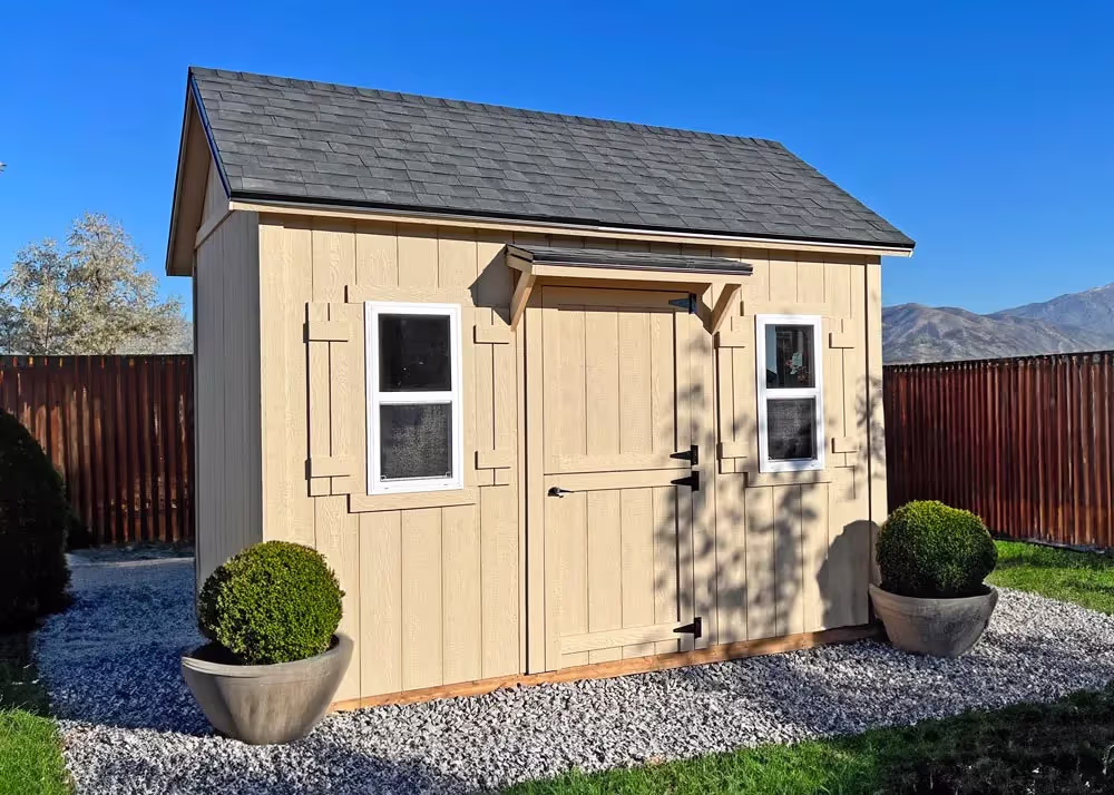 An 8' by 12' Tall apex with a porch awning over the door on a side wall