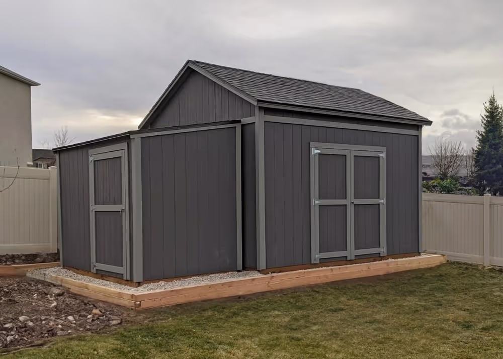 A custom Tall Apex shed with 9' high walls with a lean-to shed up next to it.