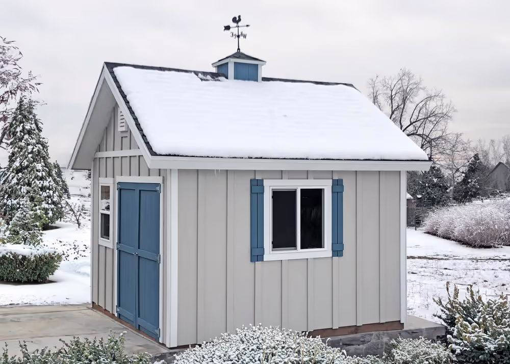 A 12 foot by 12 foot tall apex shed with board & batten siding, custom roof pitch and more in the winter