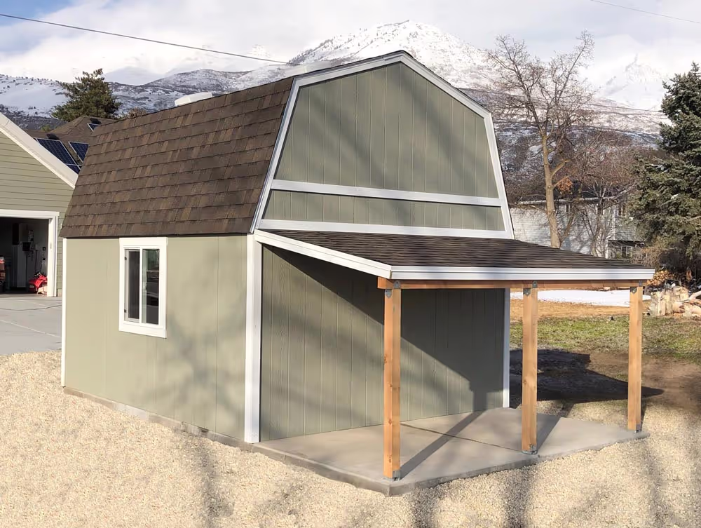 A 12 foot by 14 foot Standard Barn with a porch overhang off the back side
