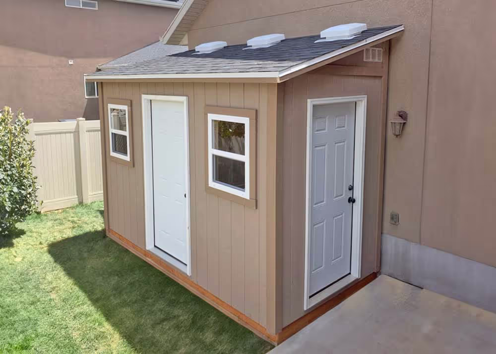 A 6 foot by 12 foot tall lean-to shed with two steel entry doors and windows