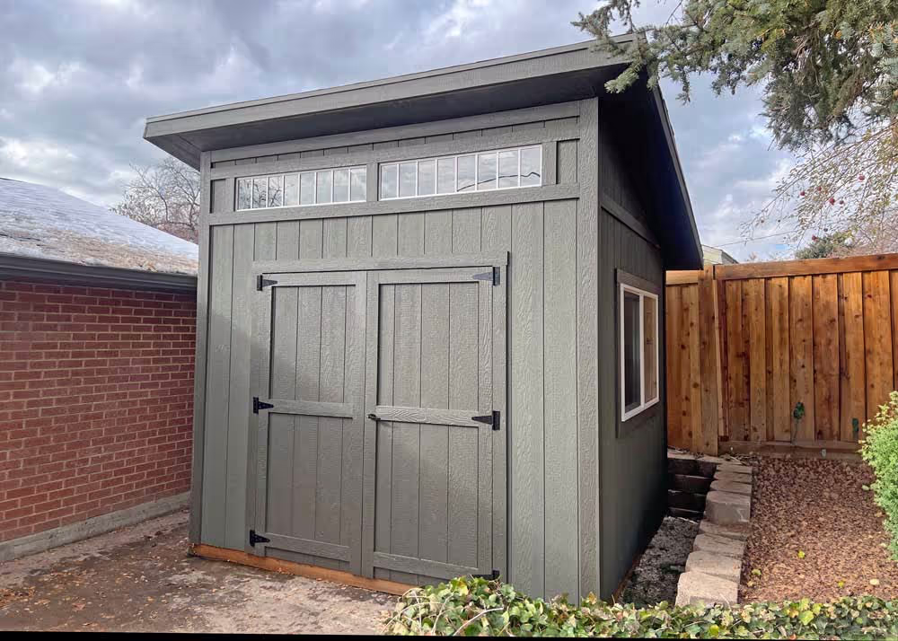 A 10 foot by 10 foot lean-to shed with board and batten siding