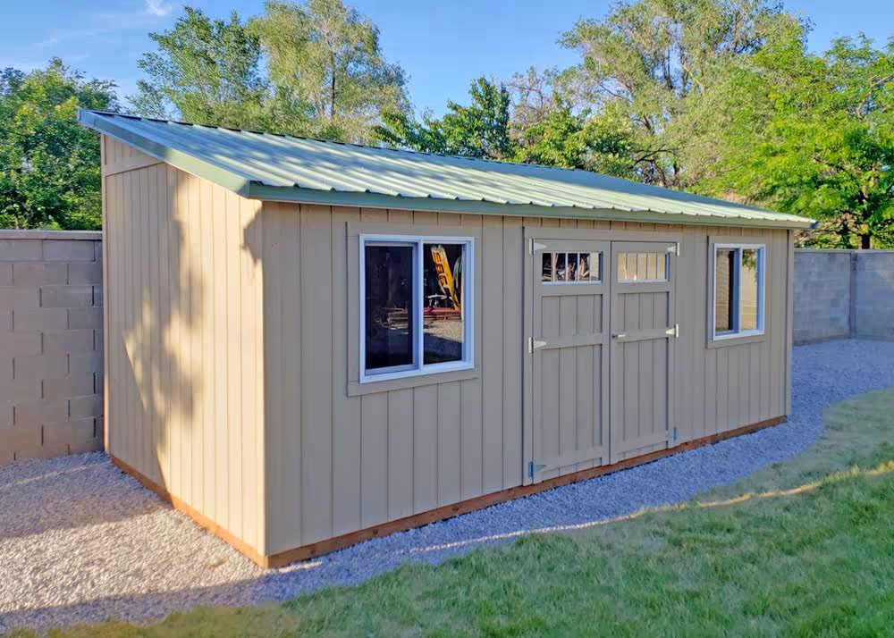 A 10 foot by 20 foot Lean-To storage shed with a green metal roof