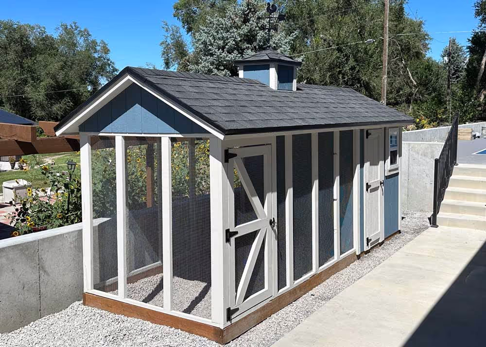 A Blue and Tan 6 foot by 16 foot Coop De'Ville chicken coop