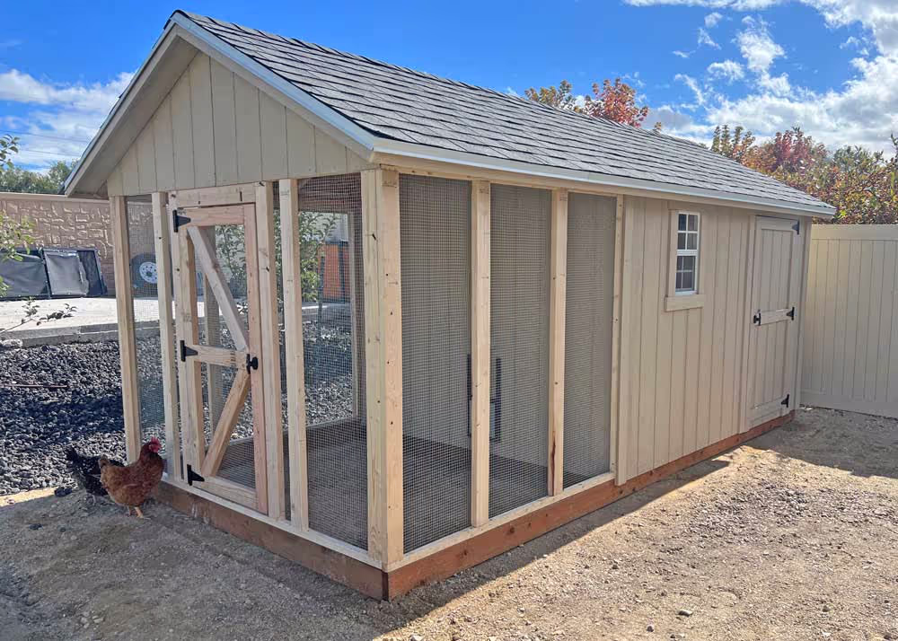 An 8 foot by 16 foot Coop De'Ville chicken coop that is unpainted