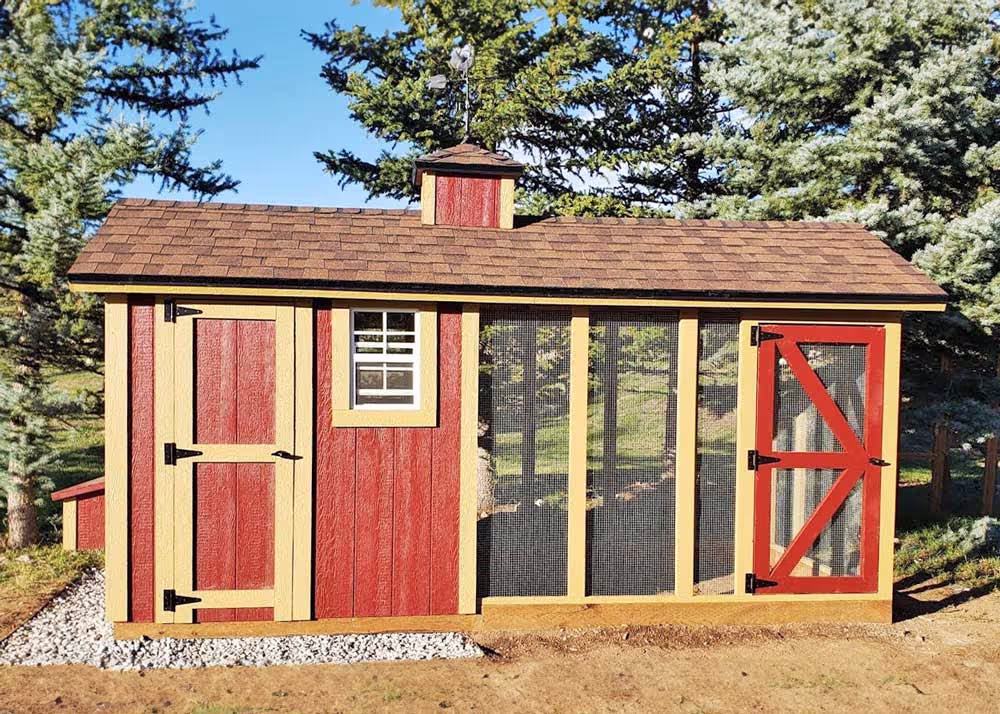 A red and Tan 6 foot by 12 foot Coop De'ville Chicken Coop with a cupola and weathervane
