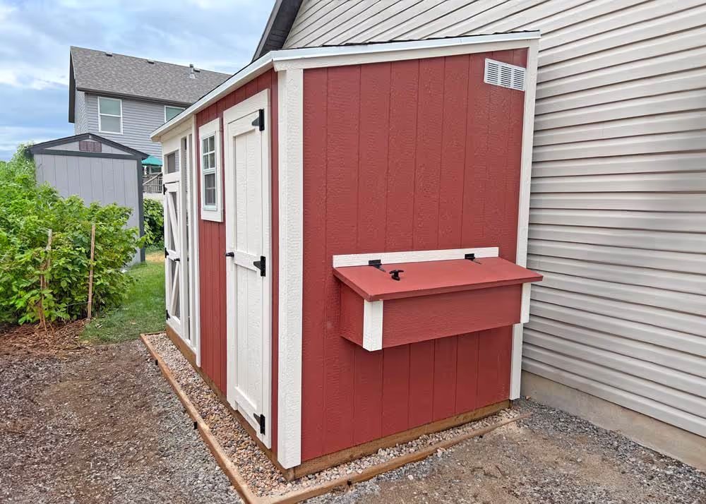 A custom Red and White Lean-To Shed chicken coop with a run