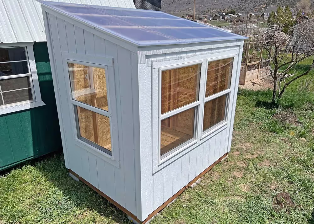 A 6 foot by 8 foot Lean-To Style Greenhouse shed