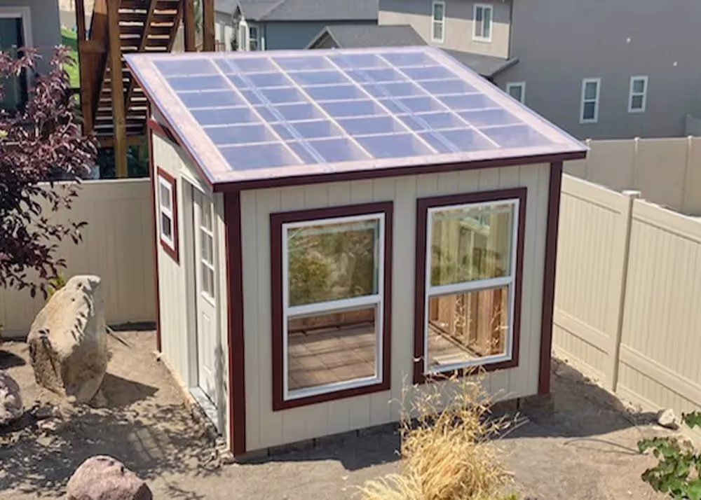 An 8 foot by 10 foot Lean-To Greenhouse with polycarbonate roofing and large windows