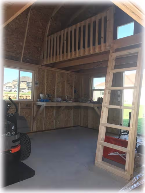 The inside of a Tall barn Shed with a playhouse loft inside