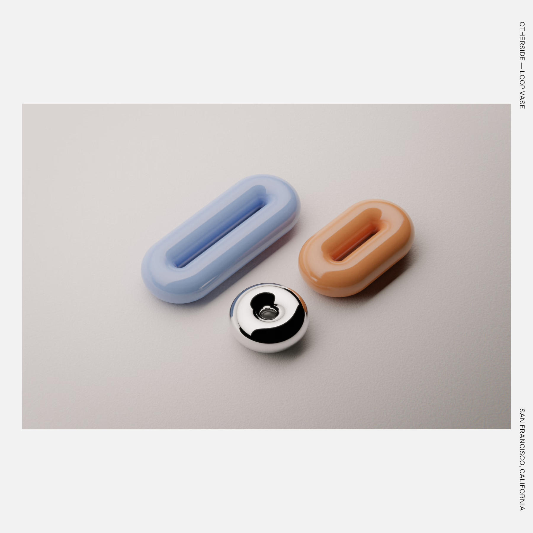 Loop Vases with a looping, fluid form resting on a concrete surface.