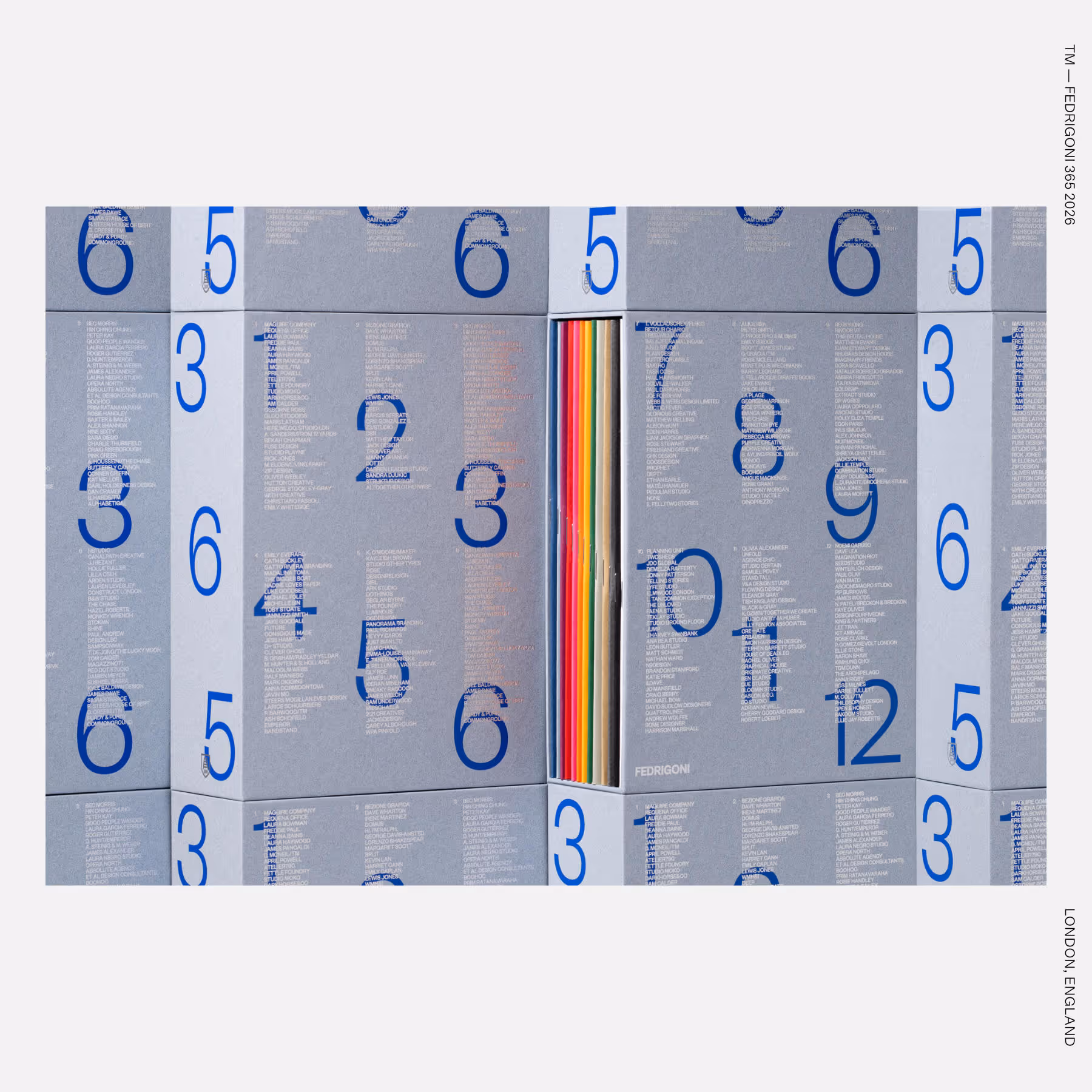 3. Wall of gray book spines with blue numerals and dense contributor text, with a central rainbow page edge.