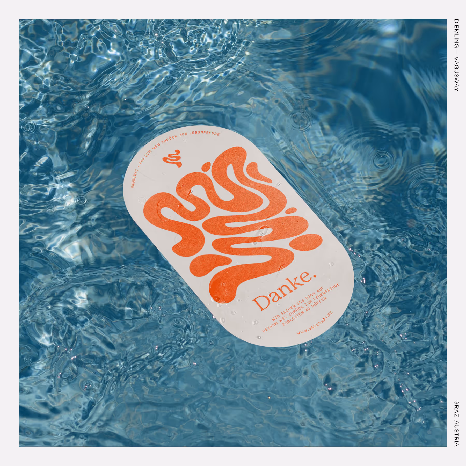 Oval sticker with orange abstract graphic and “Danke.” floating on rippling blue water.