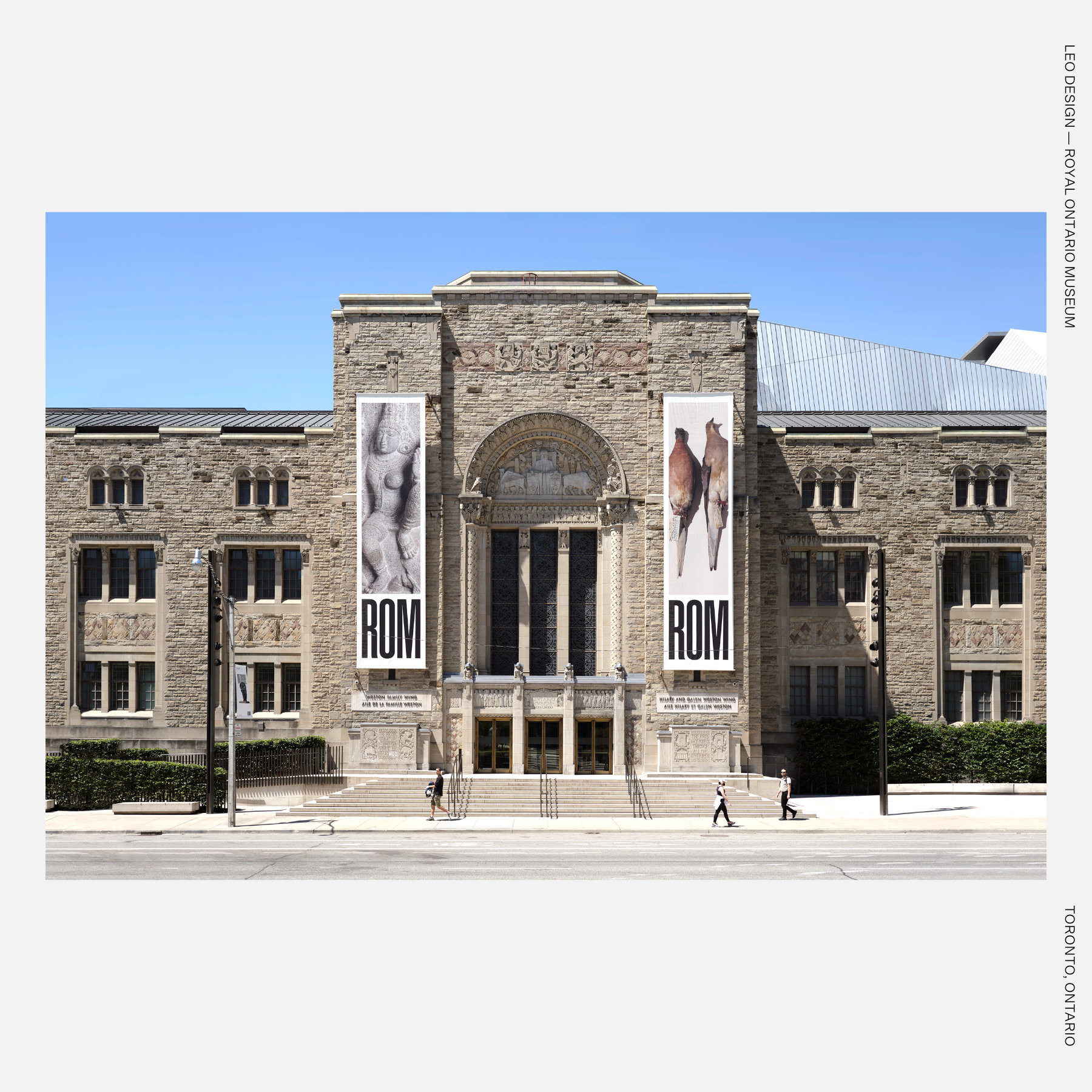 Stone façade of the Royal Ontario Museum in Toronto with large ROM banners flanking the ornate central entrance and pedestrians walking along the sidewalk.