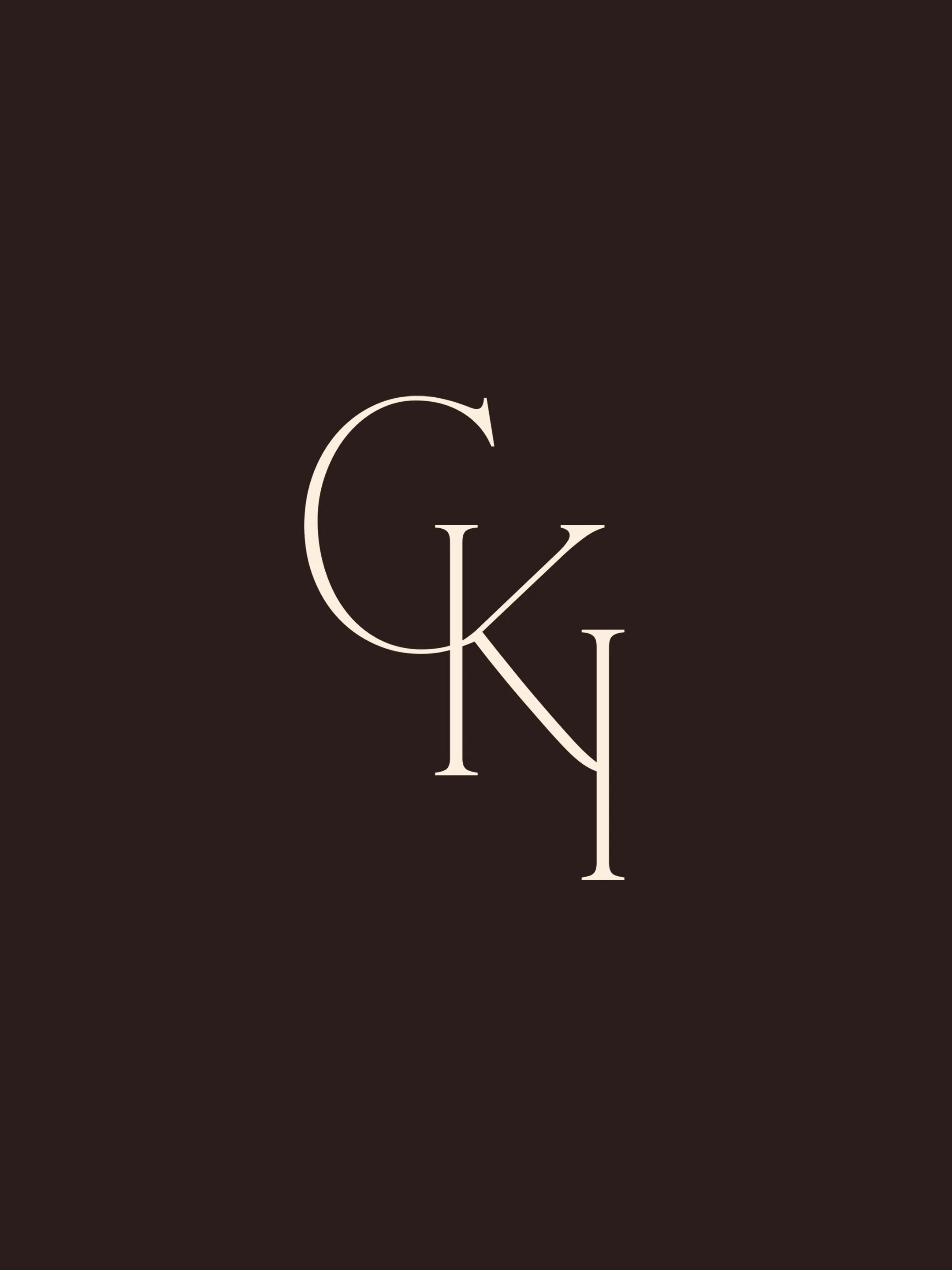 Interlocking cream CKI monogram for Caitlin Kah Interiors on dark brown.