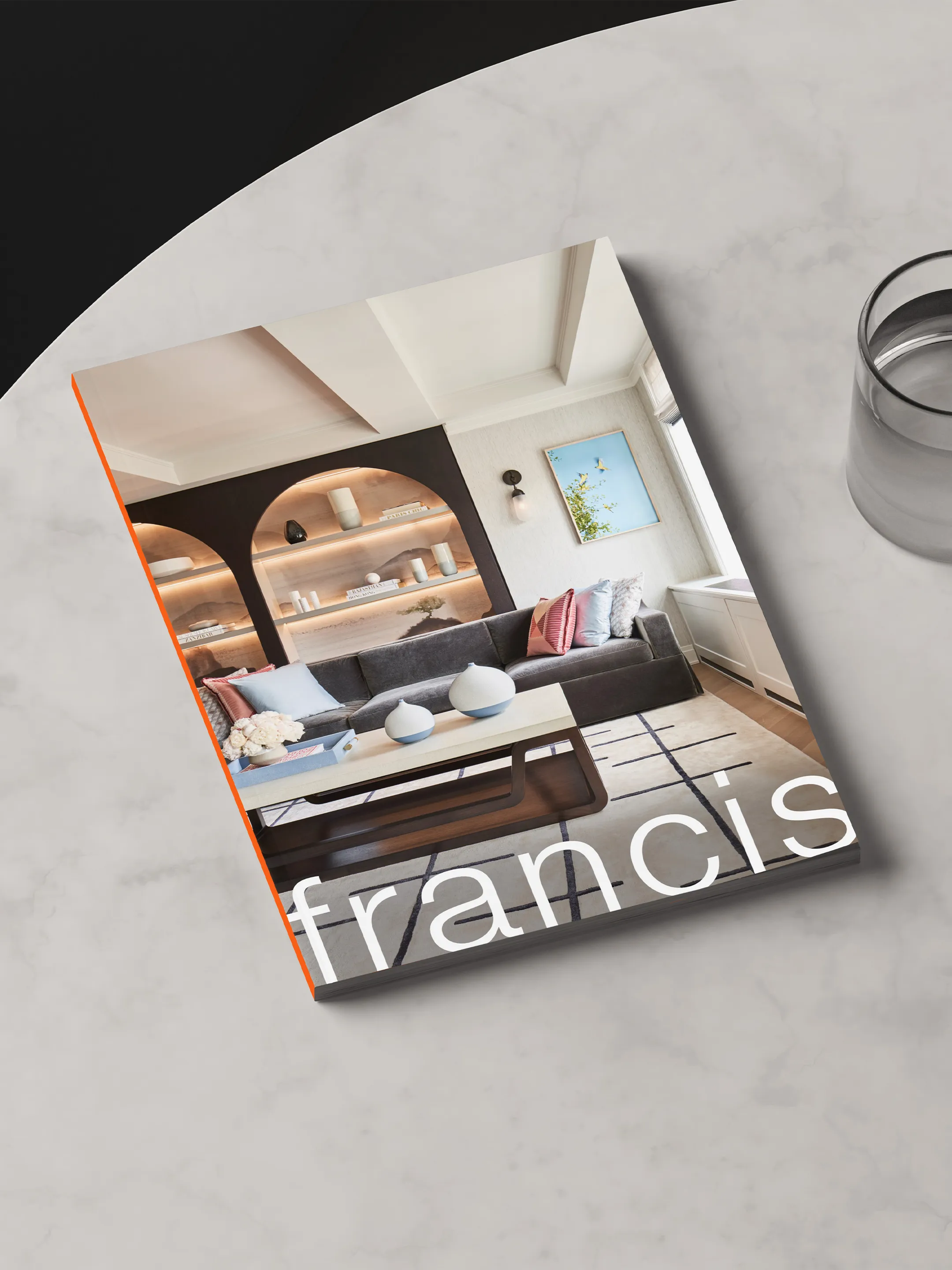 Francis Interiors book with a living room photograph on its cover, resting on a round table.