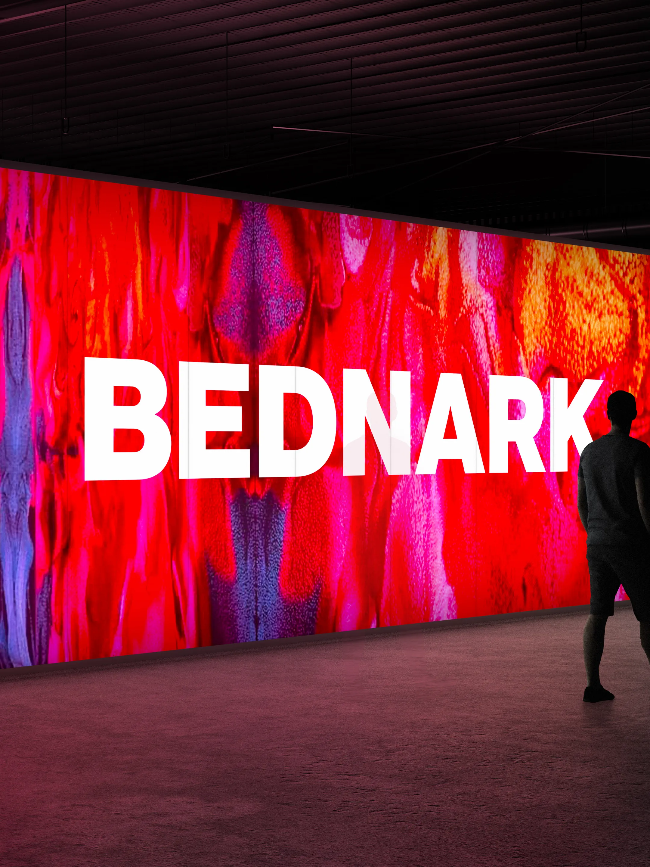 White Bednark wordmark over a vivid red and purple illuminated wall with a person walking past.