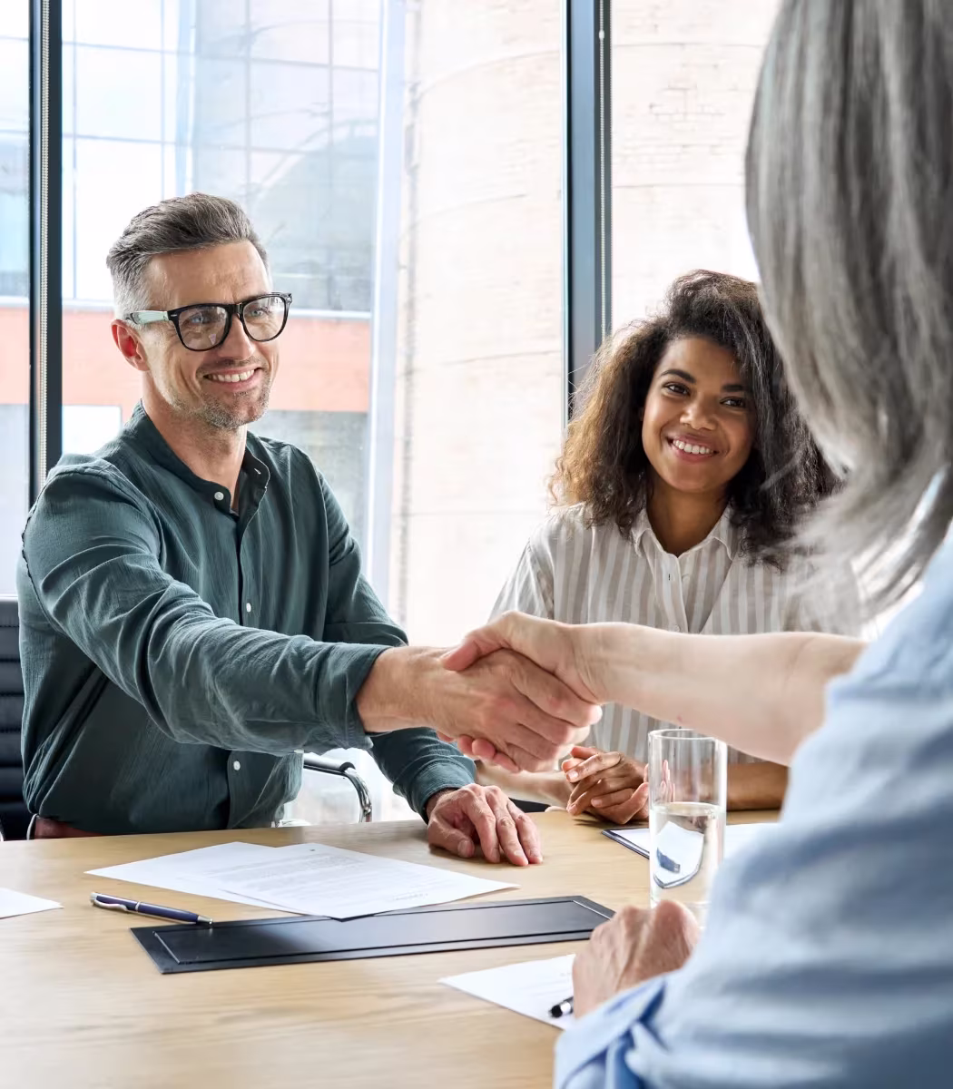 Entrepreneur shaking hands with Nova business consultant after successful strategy session