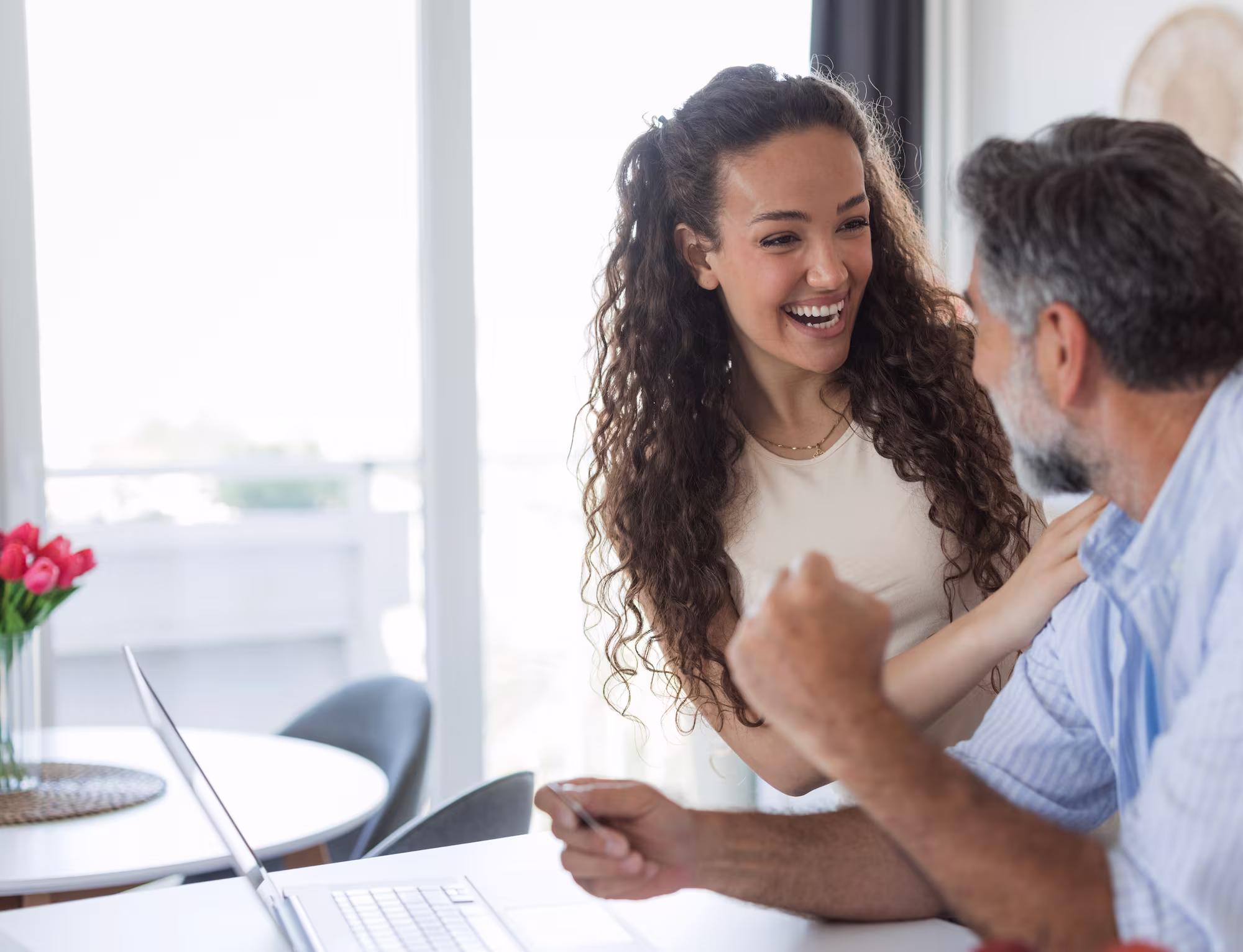 Business coach laughing with a cleaning business owner during a one-on-one strategy session