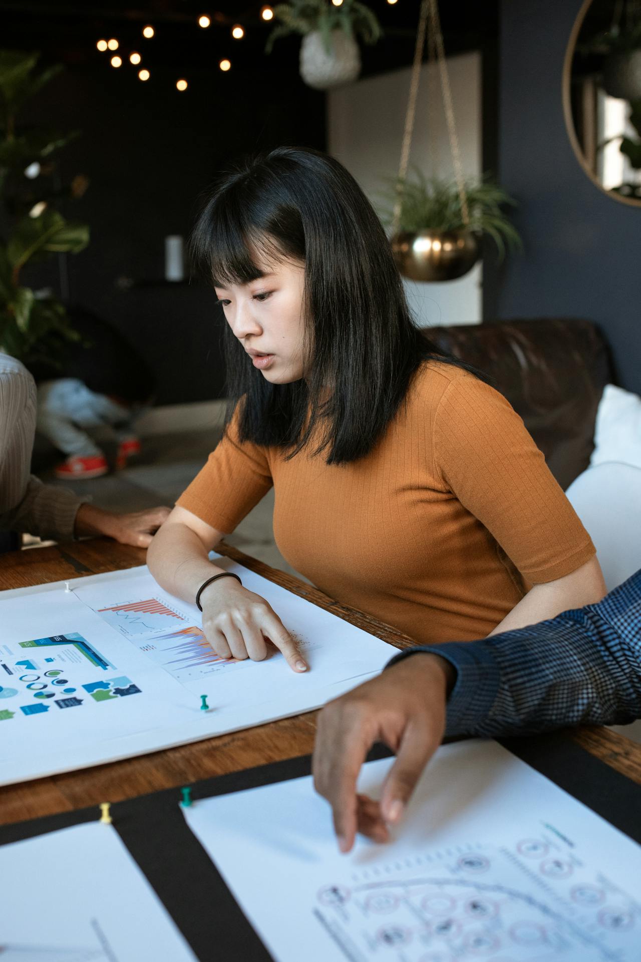 Female student sketching a science project on paper at a desk