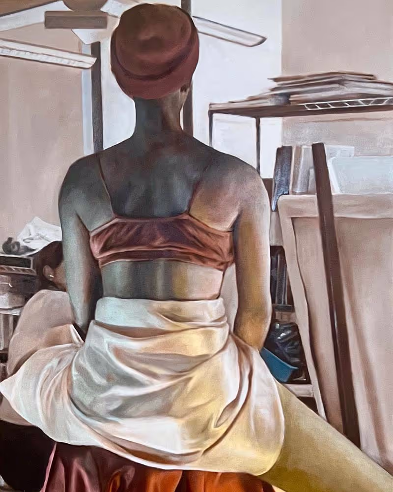 An oil painting of a model sitting on a stool and facing away with fabric draped around her and colorful lighting.