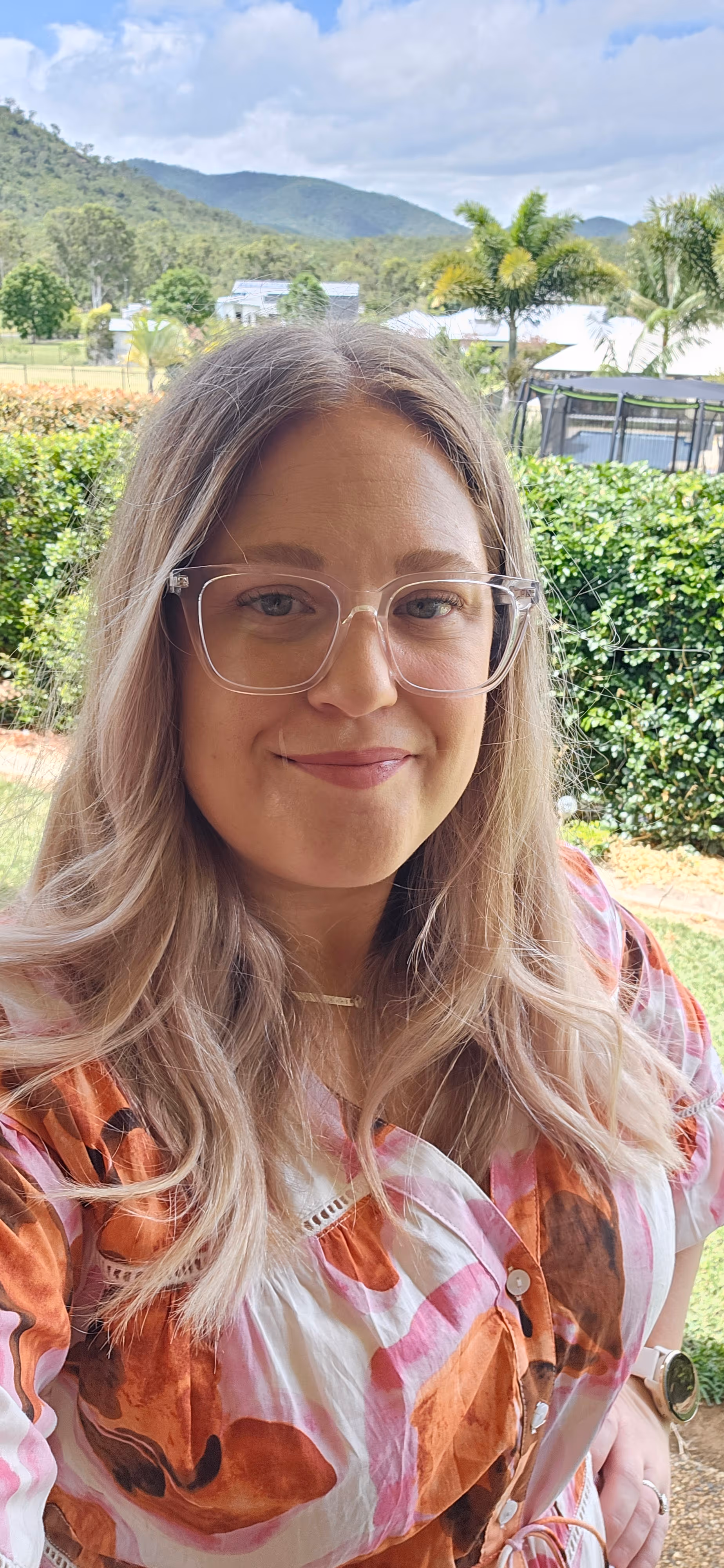 Kat Price smiles a the camera.