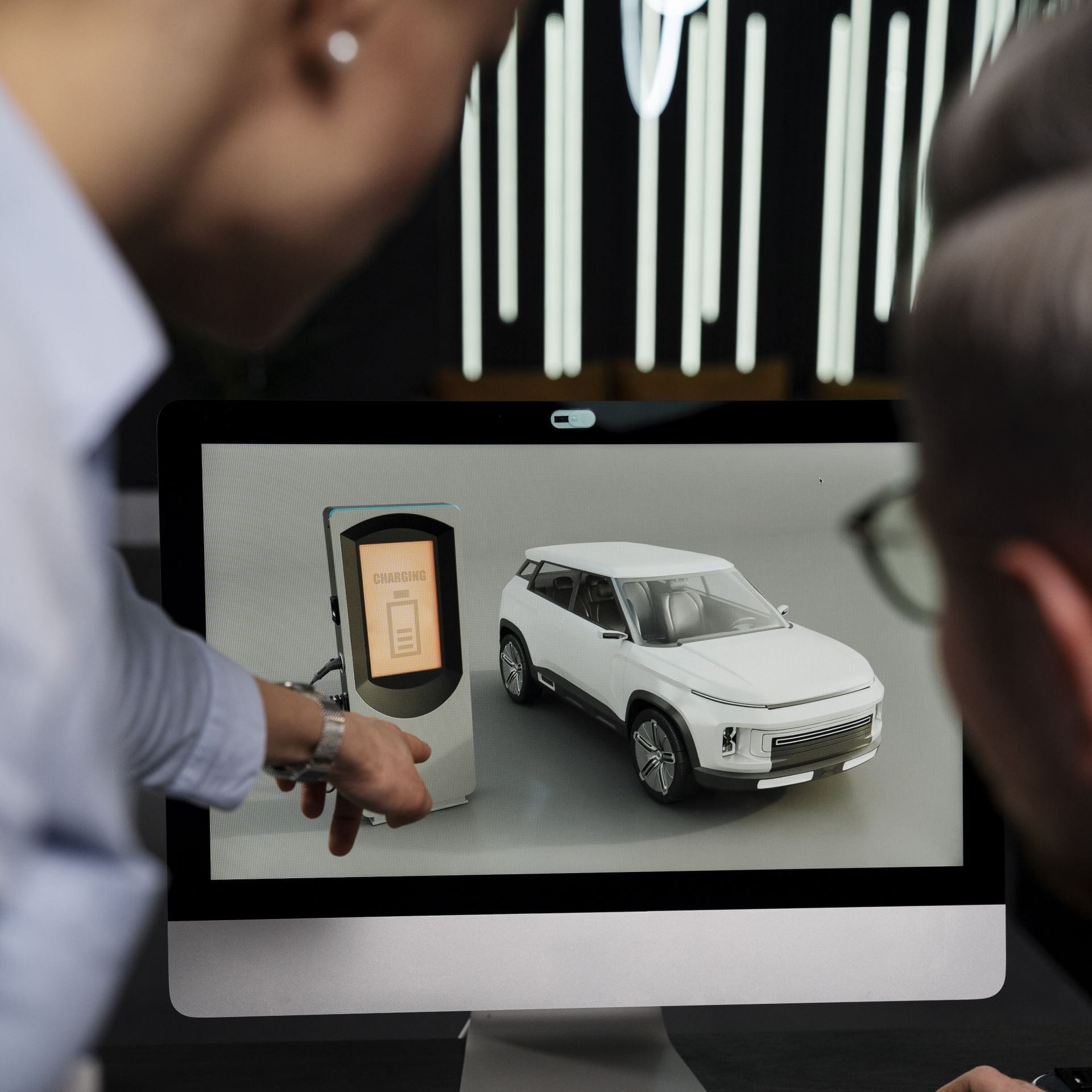 Consultor mostrando carros eléctricos baratos disponibles en Los Ángeles California en pantalla de computadora