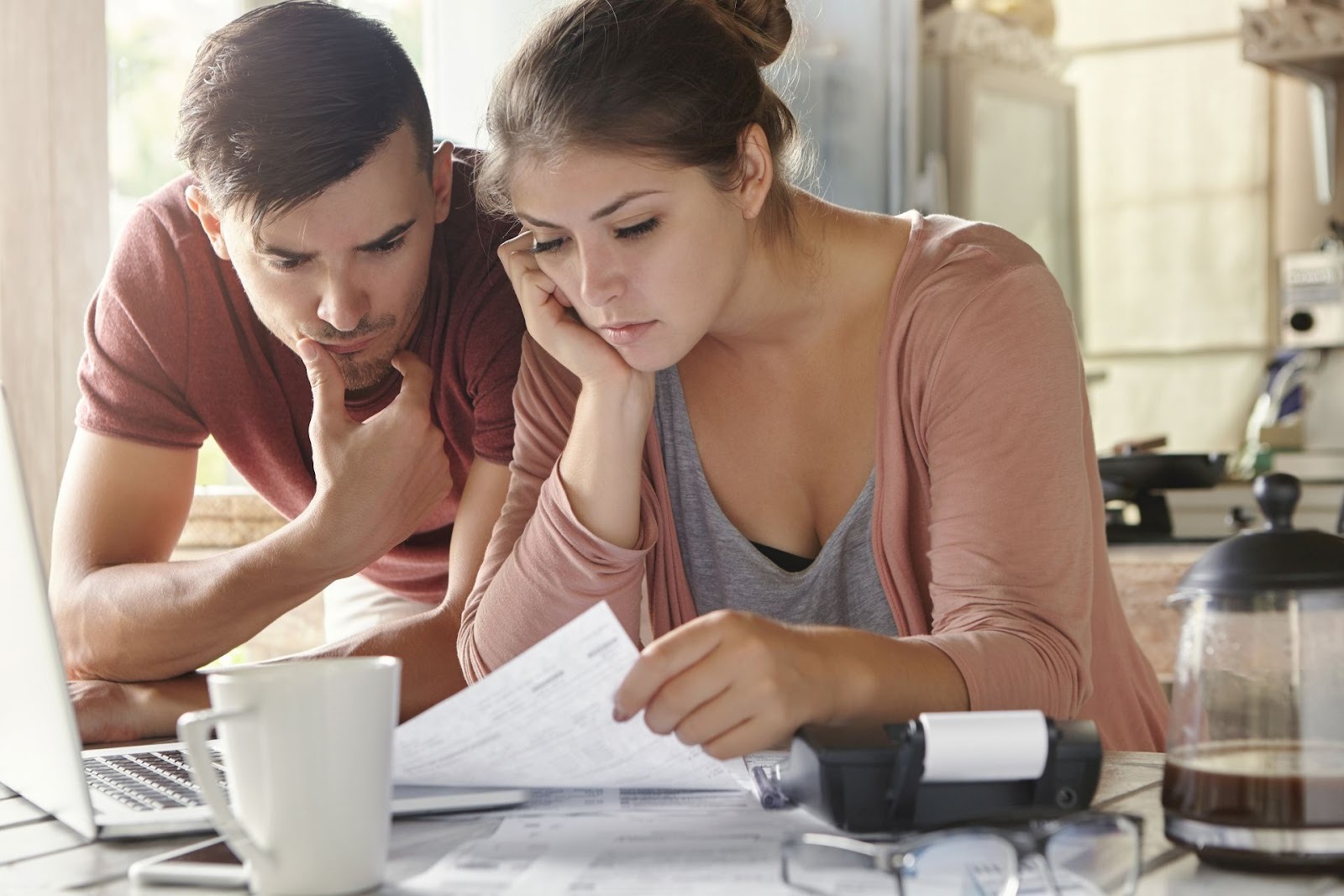 Couple reviewing auto loan rights and financial documents at home table