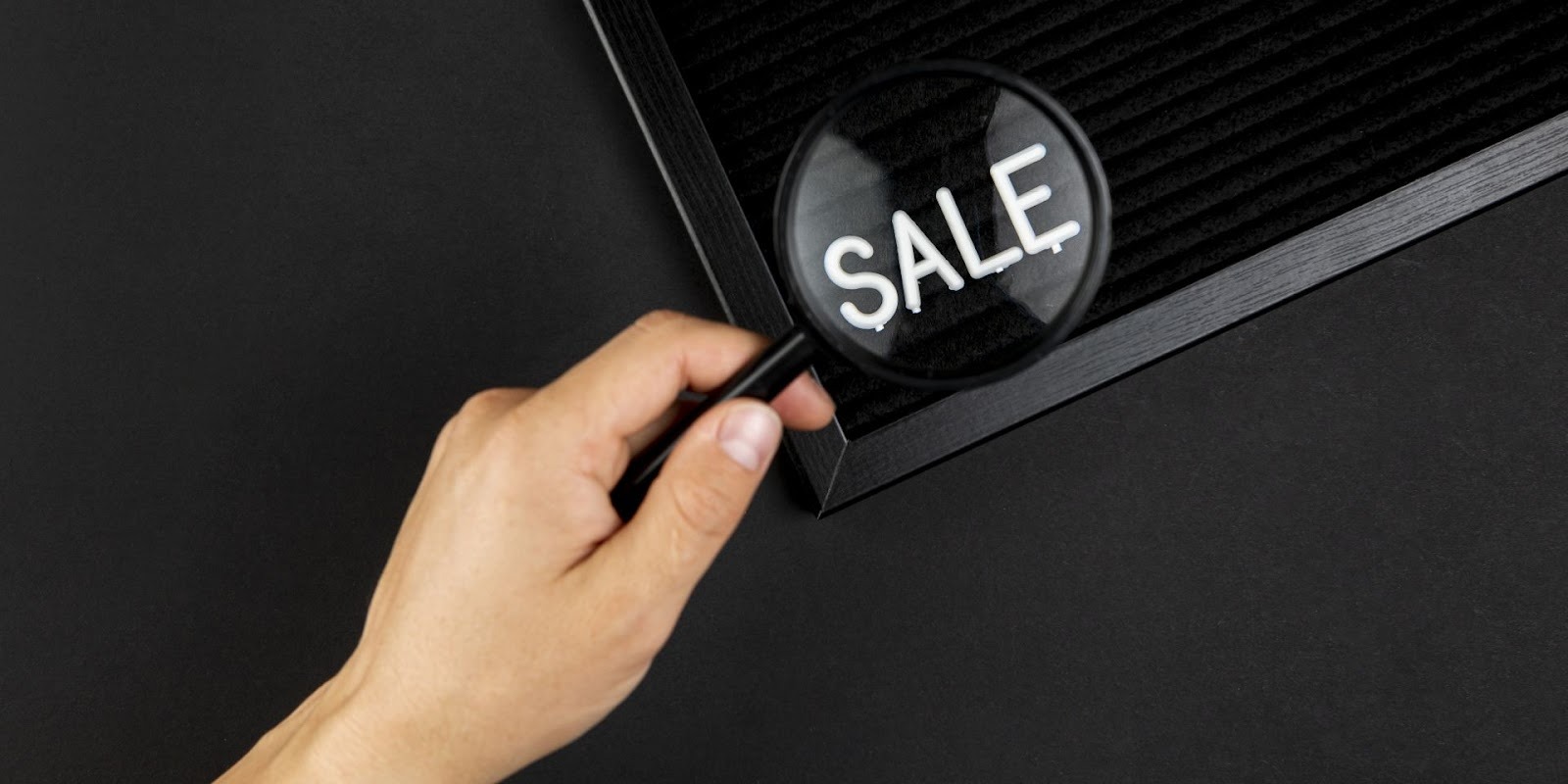 Hand opening car door with sale badge for zero down zero APR deals