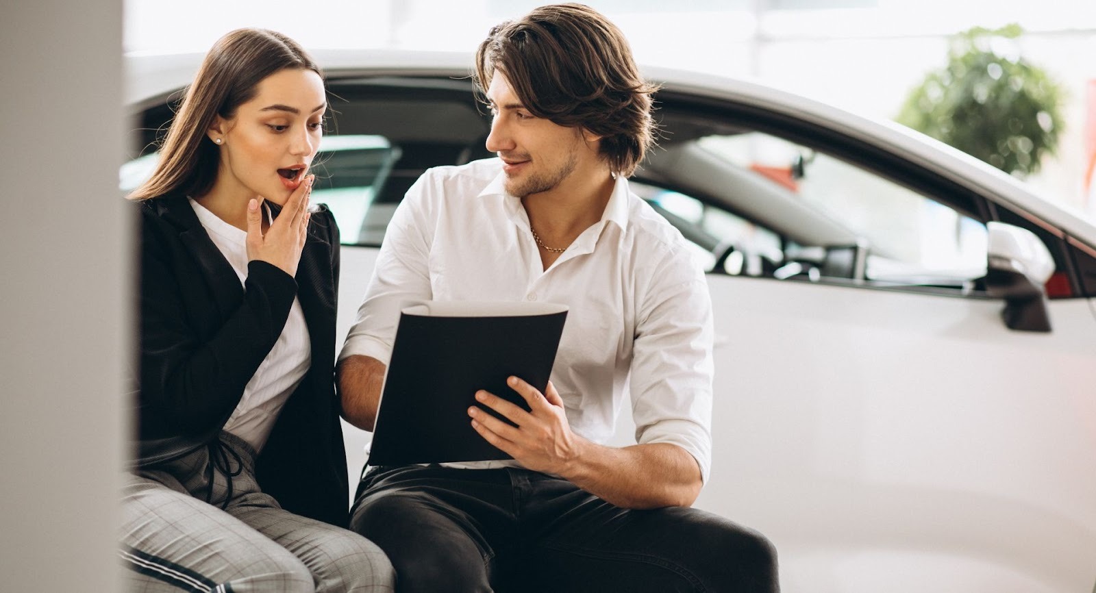 Couple reviews car buying options with concierge expert showing surprising savings