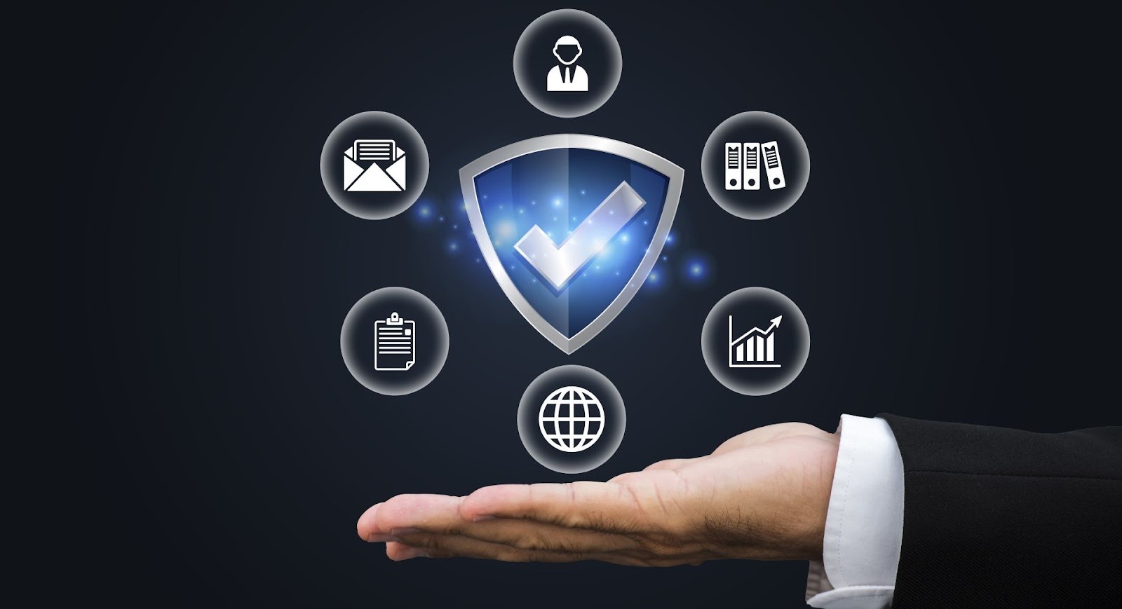 Business hand displaying blue shield checkmark icon representing verified security and trust