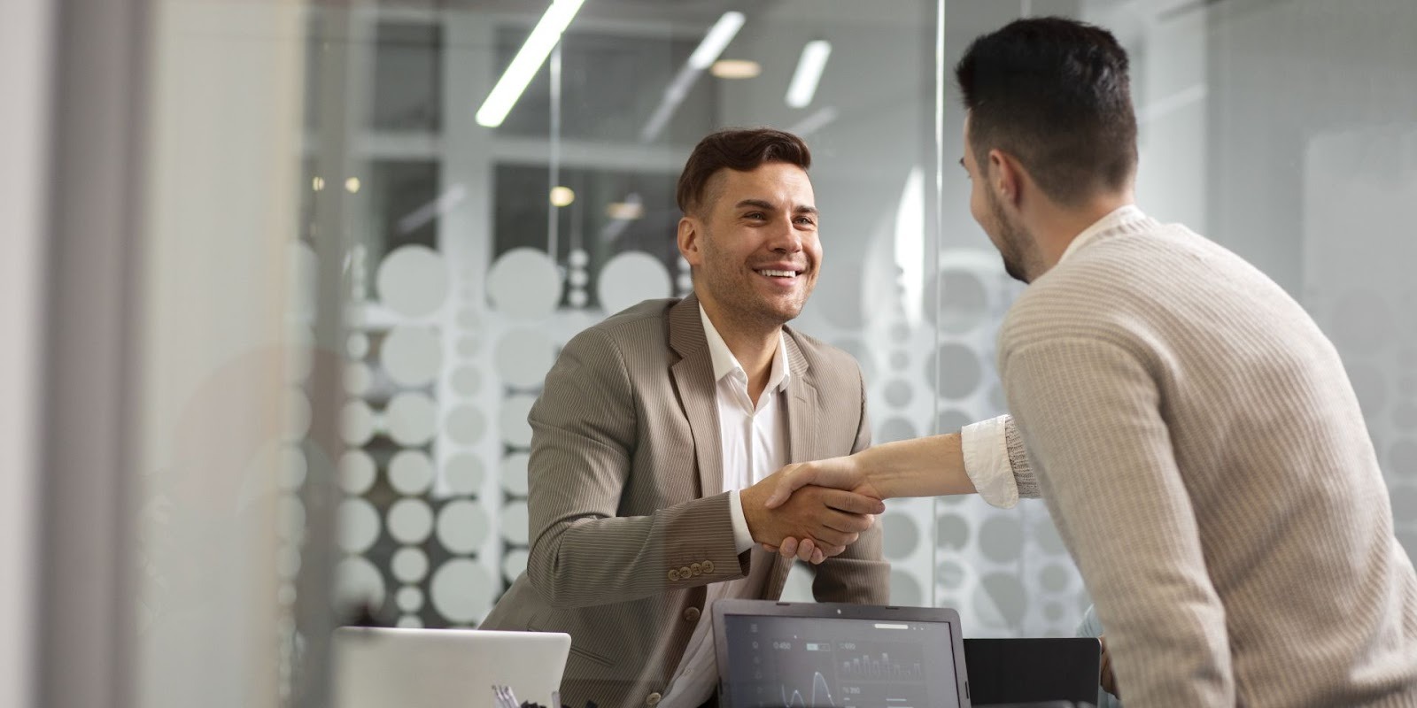 Car buyer and dealer shaking hands after successful MSRP price negotiation