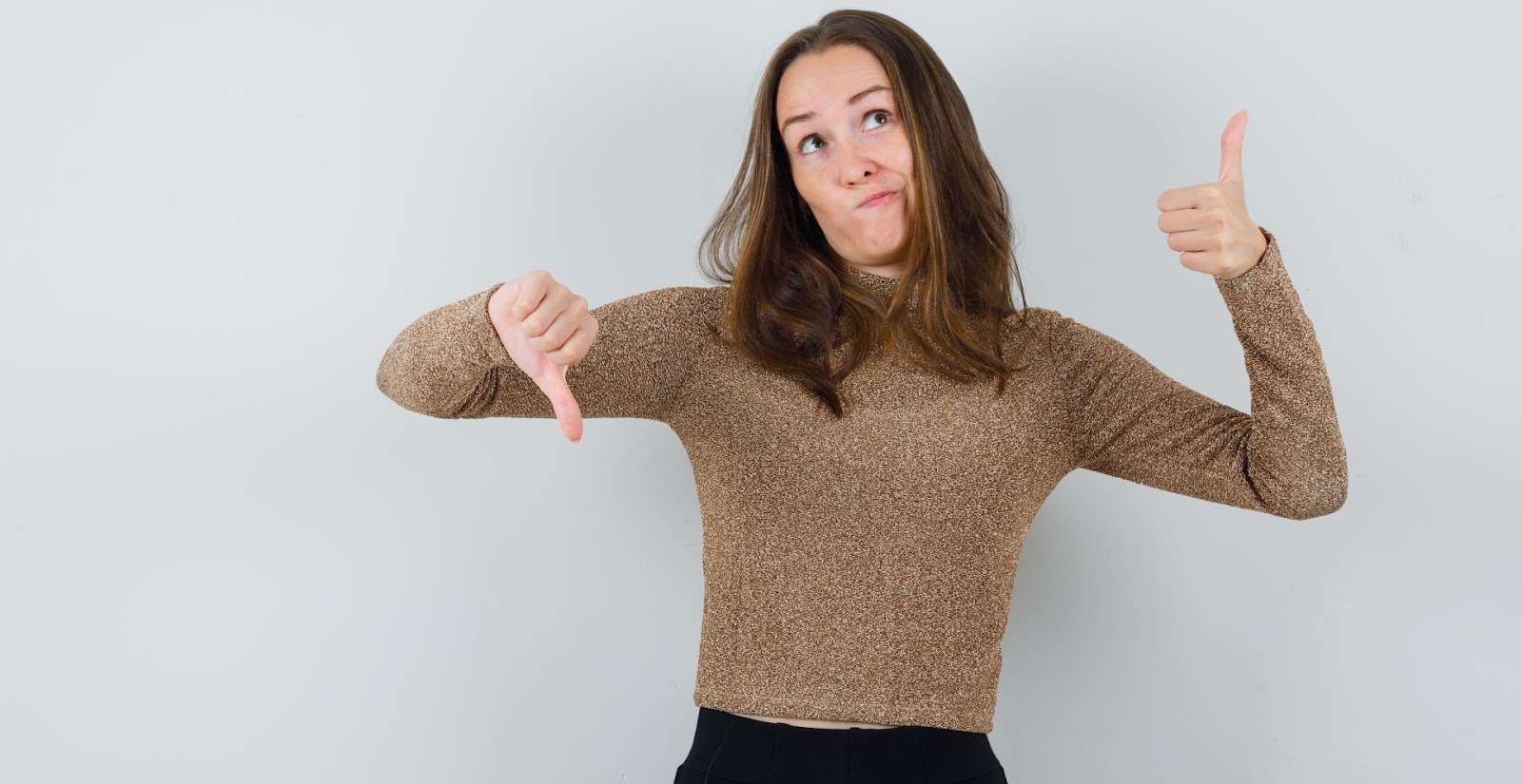 Woman showing thumbs up and down weighing pros and cons of a car down payment