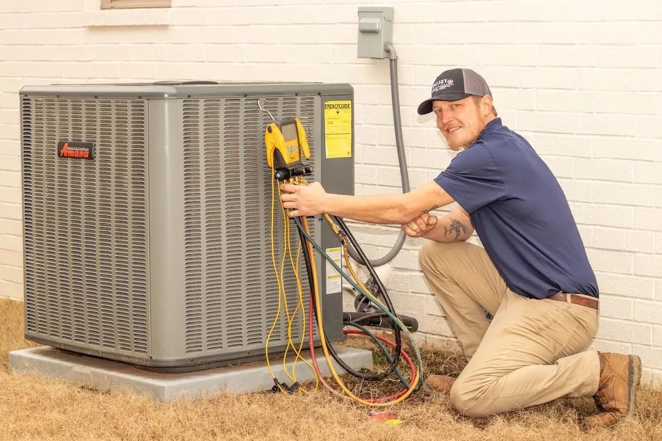 HVAC technician inspecting an air conditioning unit in a backyard, emphasizing maintenance for energy efficiency