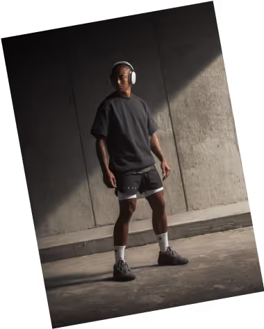person standing in front of a wall with a confidence and listeningmusic