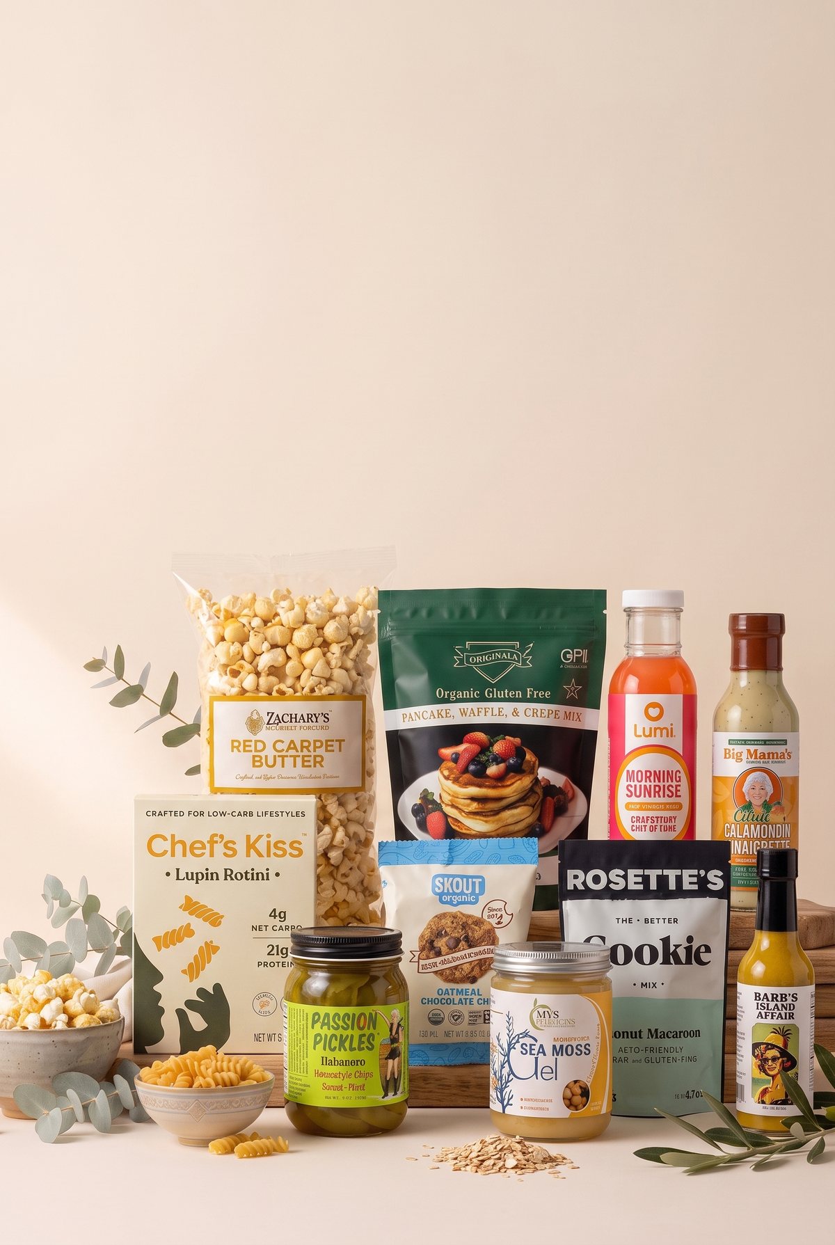 Products from independent Loyaltie brands arranged on wooden risers: Zachary's Red Carpet Butter popcorn, Chef's Kiss lupin rotini, an organic gluten-free pancake and crepe mix, Rosette's cookie mix, a Skout Organic oatmeal chocolate chip pack, a Lumi Morning Sunrise drink, Big Mama's calamondin vinaigrette, Passion Pickles, MY'S sea moss gel and Barb's Island Affair hot sauce.