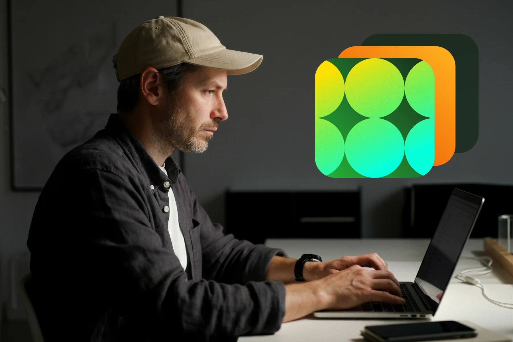 Man wearing a beige cap typing on a laptop in a dimly lit room with a colorful abstract icon overlay.