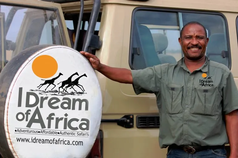 Chrisopher similing with I Dream of Africa Safari vehicle