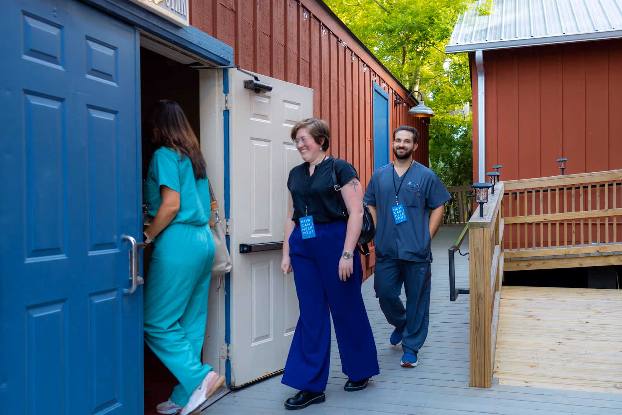 Connect Team volunteers smiling as they walking into the main entrance for a worship service at Restoration Community Church in Mandeville